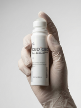 Kannaco CBD Pro Roll-On used by practitioner with gloved hand in clinic