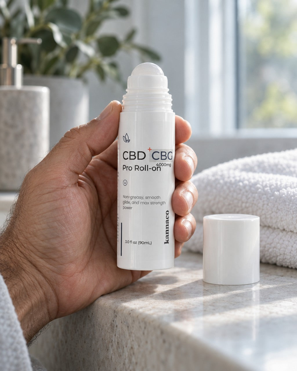 A hand holding the Pro Roll-On bottle with the cap off