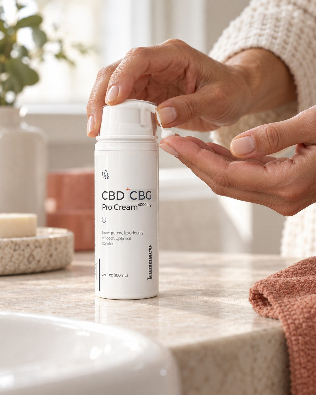 A hand pressing the pump on a bottle of Pro Cream
