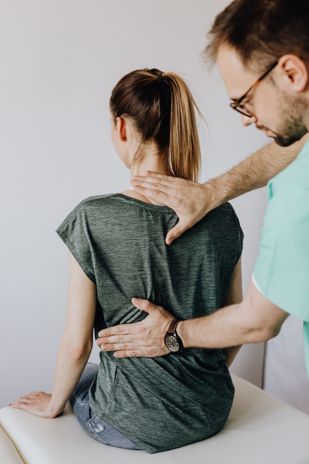 Chiropractor checking a client's upper back